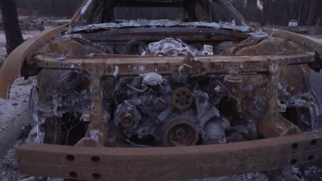 slider shot across front of burned car in paradise, california wildfire aftermath