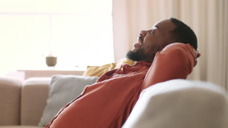 man relaxing on couch
