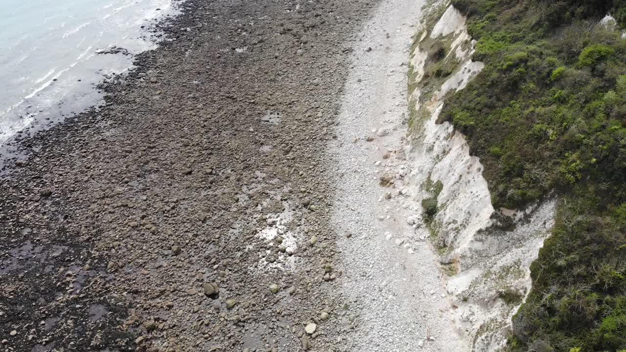 Aerial perspective showcasing the rocky coastline of Lyme Regis with Seaton undercliffs, highlighting the rugged natural beauty and geological features