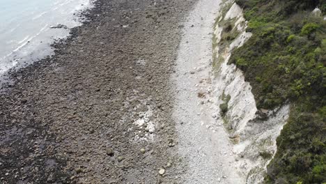aerial perspective showcasing the rocky coastline of lyme regis with seaton undercliffs, highlighting the rugged natural beauty and geological features
