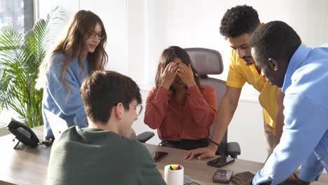 startup team celebrating success in modern office
