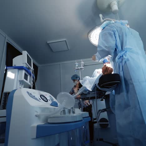 modern equipment during surgery. doctor and assistant in the operating room. saving patient's life during pandemic. covid-19.