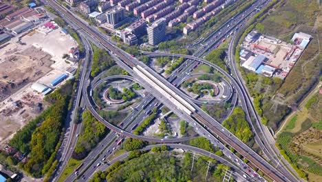 time lapse of aerial view of highway junctions with roundabout. bridge roads shape circle in structure of architecture and transportation concept. top view. urban city, shanghai, china.