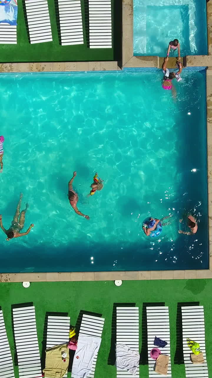 Happy people swimming in the blue pool, doing aerobics around and ...