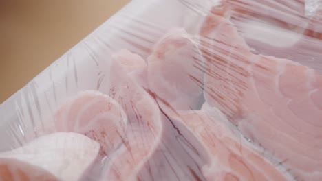 raw salmon fillets in plastic packaging