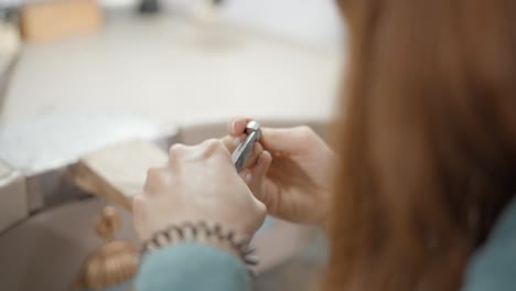 woman jewelry maker working on a ring