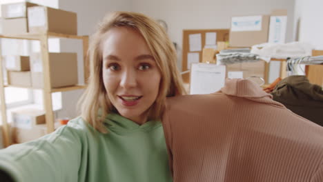 woman showing clothing items in a showroom