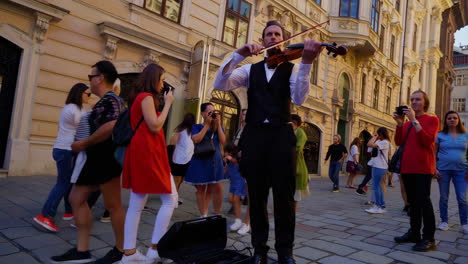 street violinist entertains tourists in european city