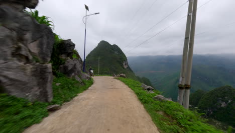 Exploring Ha Giang Loop in Vietnam on a scooter, riding through winding mountain roads and breathtaking landscapes, solo adventure, driver POV