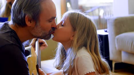 father and daughter kissing each other in living room 4k