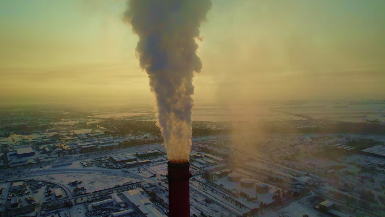 Industrial Plant with Smokestack in Winter