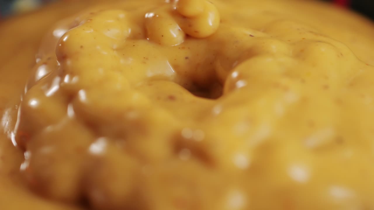 Indian yellow curry sauce for fish and meat close-up. Spicy sauce for many various dishes. Meat or vegetables, oil or ghee, spices. Mustard. High quality 4k footage