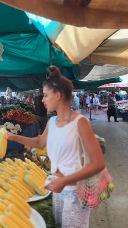 woman shopping for fresh produce at a farmer's market