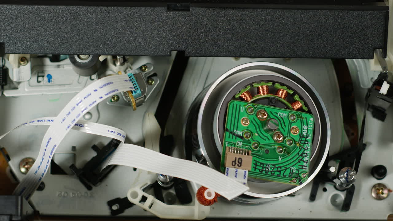 Old video recorder inside close-up, VHS. Retro player in neon blue light, vintage video cassette broadcasting, audio tape.