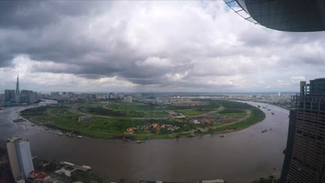 timelapse of clouds moving over the saigon river from highrise skyscraper view in ho chi mihn city