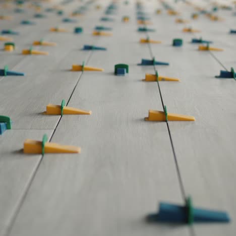 ceramic tiles are glued to the floor in even rows