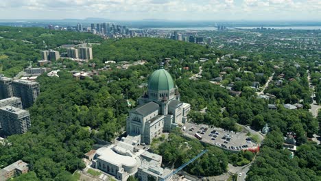 4k cinematic urban landscape footage of a drone flying around the observatory saint joseph in montreal, quebec on a sunny day, behind mount royal capturing a beautiful panoramic view