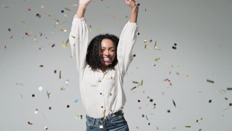 joyful excited woman at celebration party with confetti falling everywhere