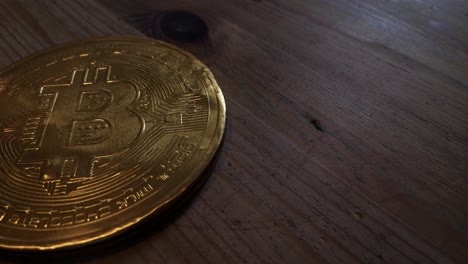 wrapped chocolate gold bitcoin crypto currency concept on wooden kitchen table right orbit top down shot