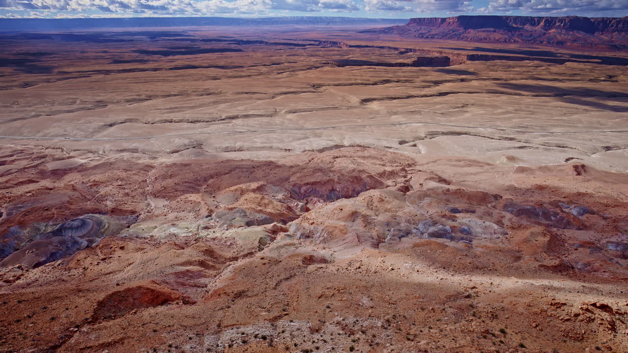 Stunning aerial footage of rocky spires and layered colors in the toadstool hoodoos region.