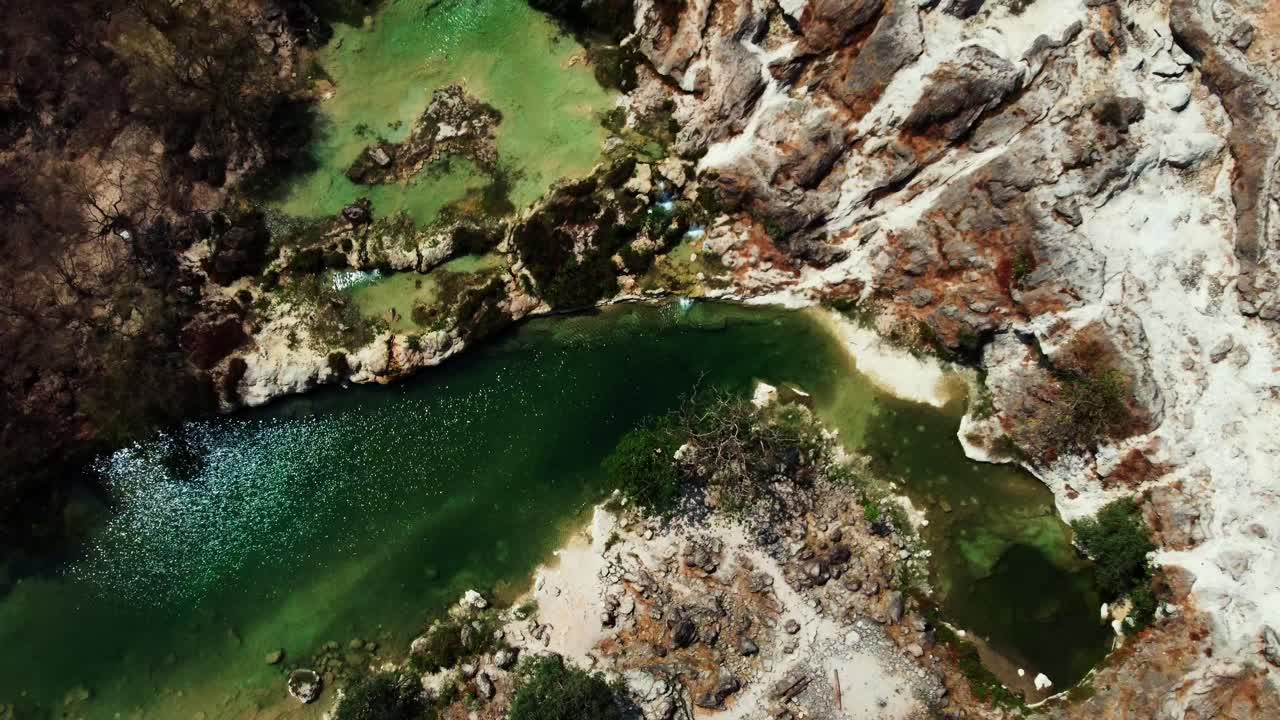 Aerial view of Wadi Darbat, Oman! A picturesque valley with waterfalls and lush greenery during Khareef season. Watch now!