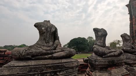 decapitated buddha statues at historical site