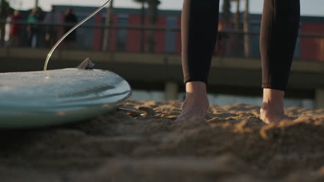 Surfer man walking to the beach at sunset preparing for surfing training and search for waves in Barcelona, spain, water, ocean exercise in sea with board, athletic male holiday or travel in vacation