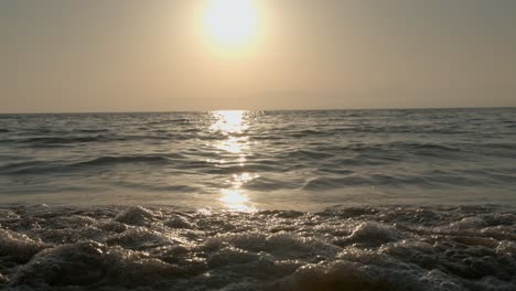 Colorful-dramatic-sunset-over-ocean-or-sea-waves-and-beach-in-a-sunny-day-in-Caribbean-sea