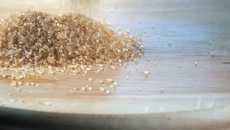 brown sugar being poured on to a wooden board