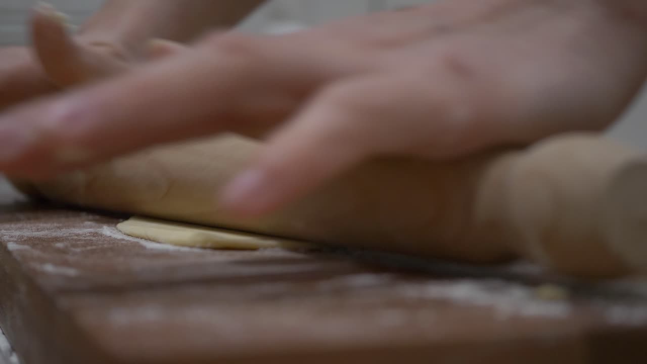 Rolling all purpose flour dough to make Faworki polish dish