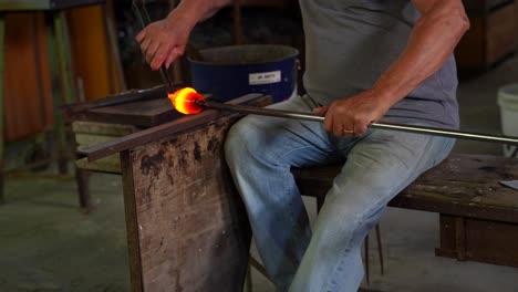 craftsman molding incandescent murano glass in italian factory workshop