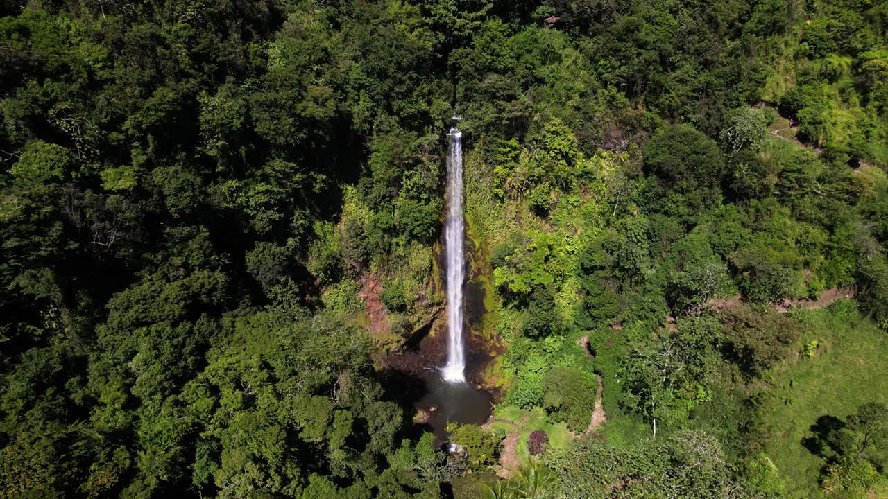 tomada estática desde arriba de una gran cascada en el entorno verde de la selva tropical de costa rica