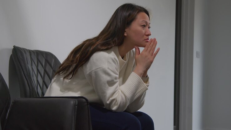 Unhappy Woman Suffering With Depression And Anxiety Sitting In Reception Of Doctor Or Mental Health Worker 1