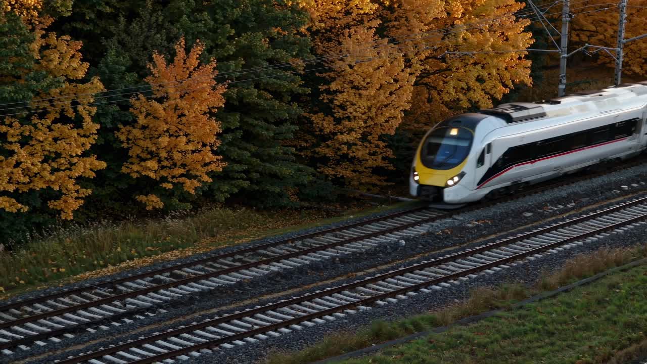 Autumn train scene captured from a high angle, showcasing vibrant fall foliage