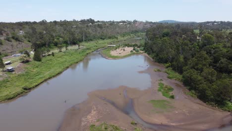 Aerial-view-of-a-small-river-with-an-island-in-it-with-a-lush-green-banks