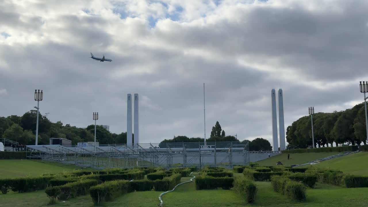 Parque Eduardo VII Park view and an airplane arrival at Lisbon Airport, Portugal.