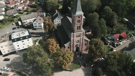 drone in germany does a 360 aerial around a church in baden-baden during a wedding