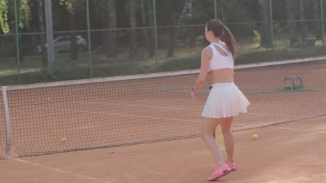 female tennis player practicing serve on outdoor court