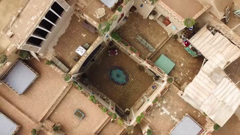 blue pool in the yard in a historical house mud brick adobe and hand made material in traditional architecture design of ancient house in iran middle east is so eco friendly and wonderful for lodging