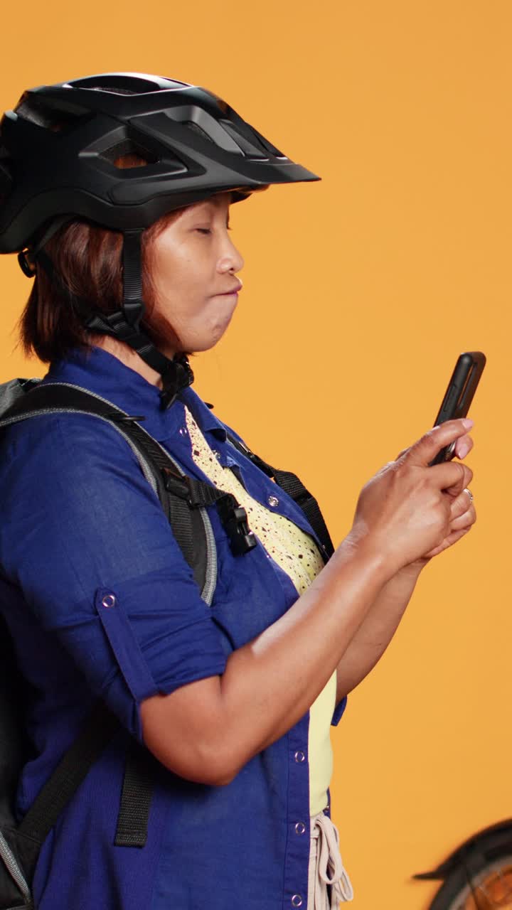 Asian delivery person using phone