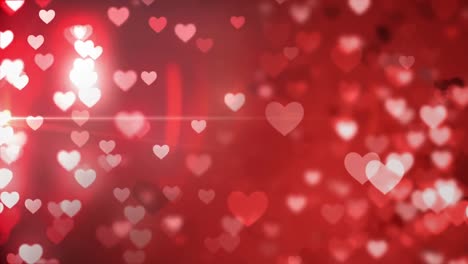 animation of falling glowing red hearts over dark background