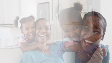 composite of happy african american mother and daughter embracing and laughing at home