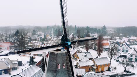 Beautiful-View-Of-Dutch-Windmill-And-Colorful-Houses-In-Winter---aerial-shot