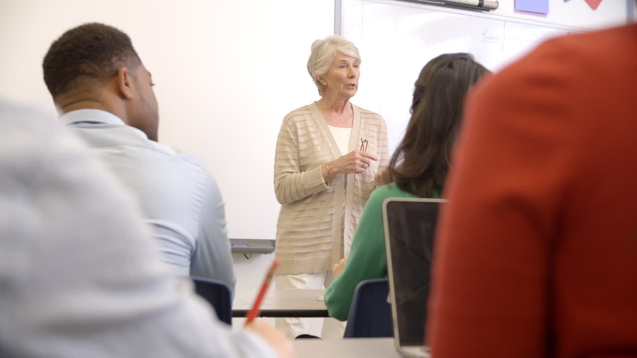 Senior woman with tablet teaching adult education class