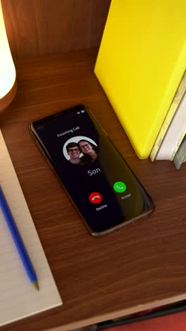 vertical shot of incoming call from your son. concept of calling your parents.