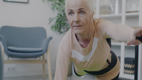 senior woman doing yoga/exercise at home