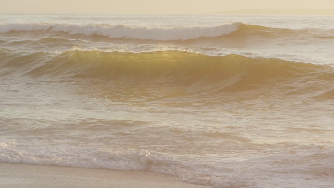바다의 파도와 푸른 하늘은  ⁇  비어 있는  ⁇ 빛 해변에 있습니다.