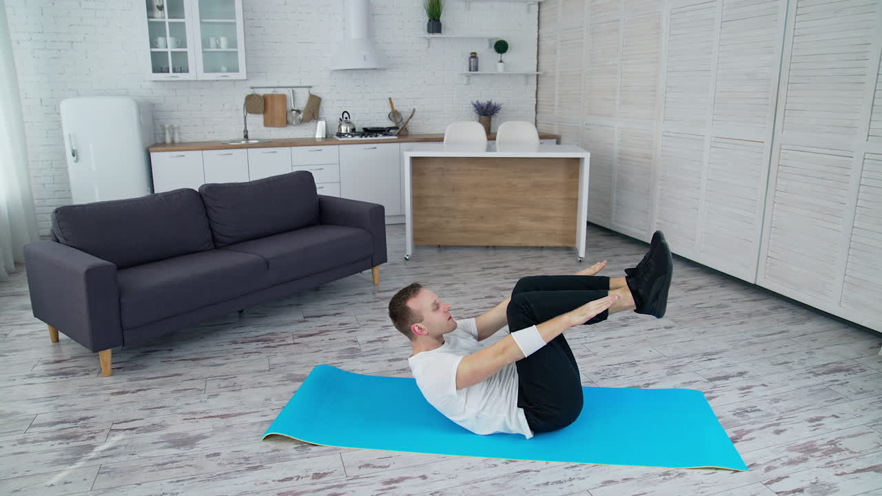 Handsome man training indoor. Lifestyle athlete body man working out in home.