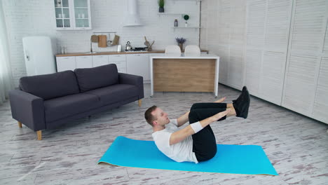 handsome man training indoor. lifestyle athlete body man working out in home.