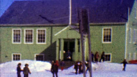 1957: one room schoolhouse kids play outside winter cold sunny day.